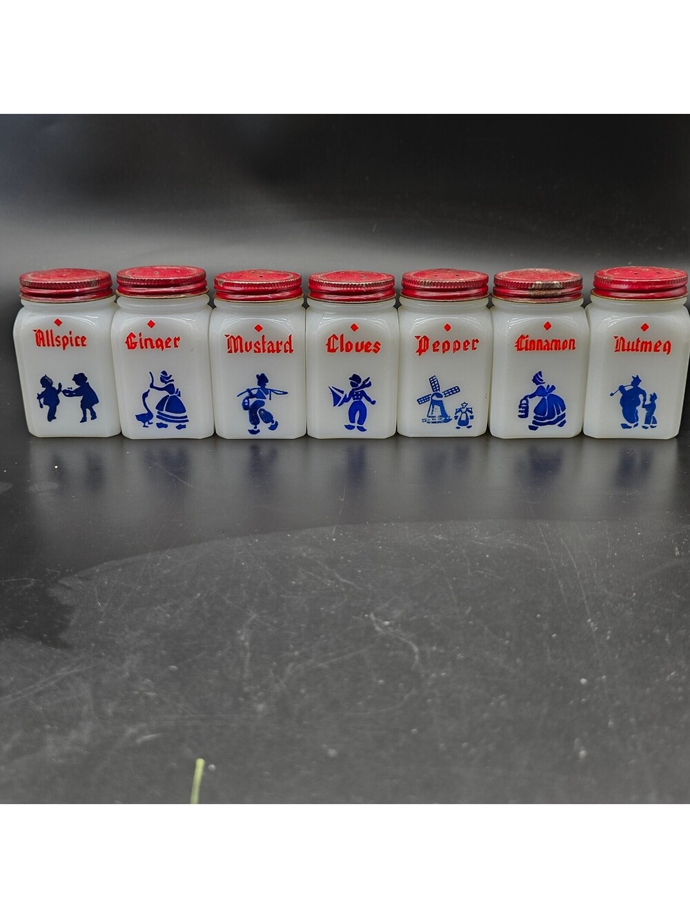 Vintage McKee Milk Glass Spice Jar Set of 7 Dutch Theme Red Lids Tipp City 1940s